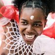 Adorned in colourful beads, a young woman is pictured in 2019 dancing before the Zulu king holding a long reed