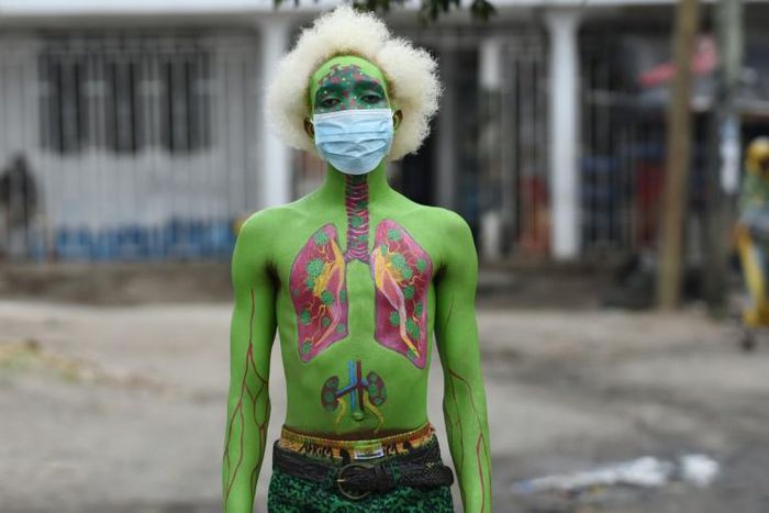 Masked: Performance artist Alex Kalemera tries to raise public awareness about the threat of coronavirus