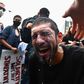 A protester has milk splashed in his eyes after being hit by tear gas during a Black Lives Matter protest in New York on May 29