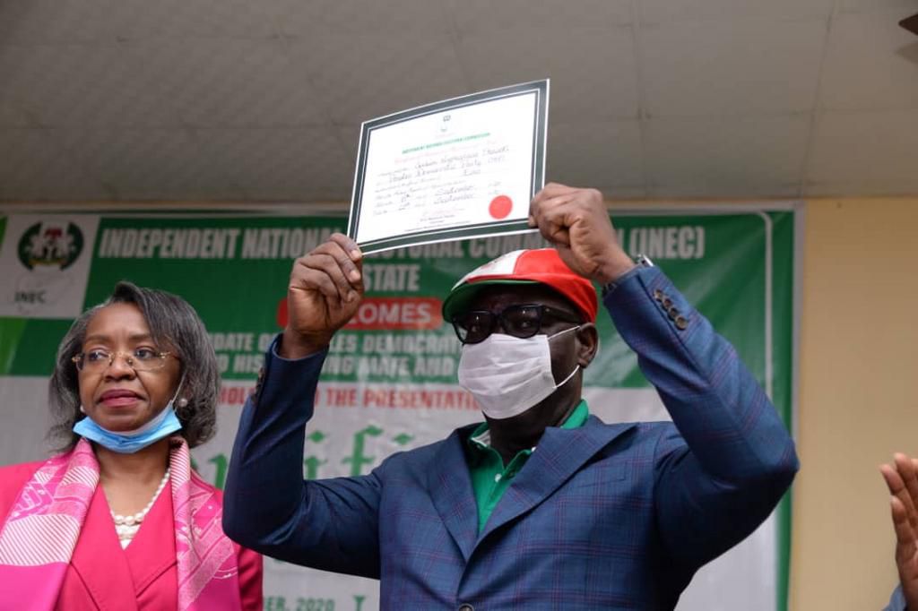 Edo's Governor Godwin Obaseki raises his certificate of return after he was re-elected for a second four-year term in office [Twitter-@GovernorObaseki]