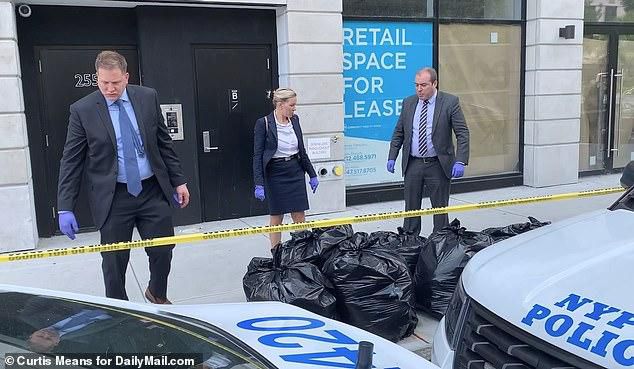 Detectives are seen outside Saleh's apartment building on Wednesday as they investigated the tech guru's grisly murder