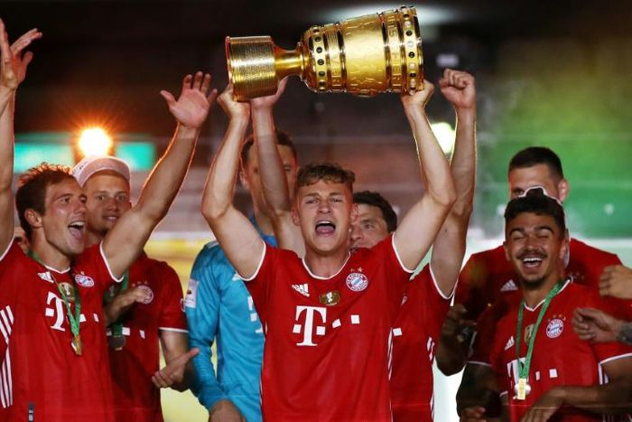 Bayern Munich midfielder Joshua Kimmich with the German Cup after a 4-2 win in Saturday's final in Berlin.