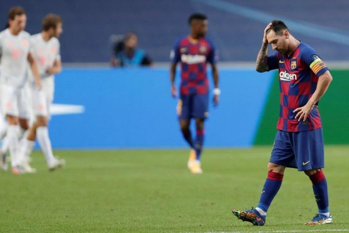Lionel Messi (R) shows his frustration after Barcelona were crushed 8-2 at Bayern Munich in the quarter-finals fo the Champions League in Lisbon
