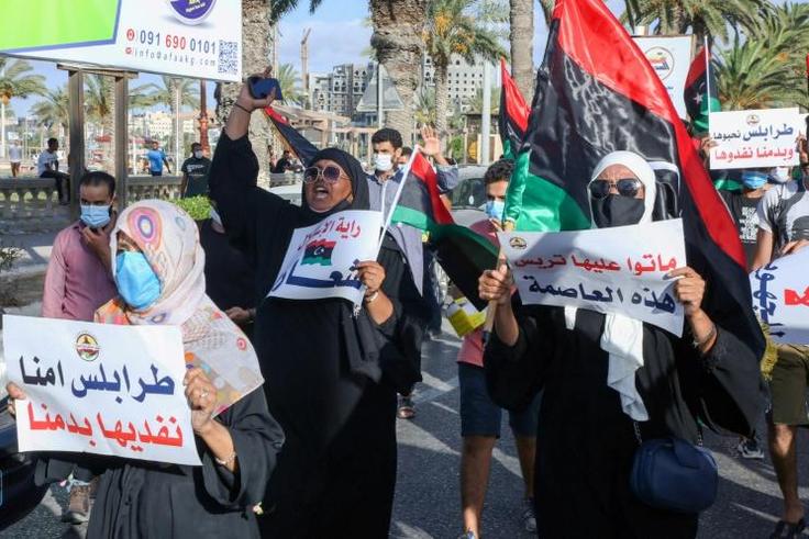 Libyans chant slogans during a demonstration over poor public services at Martyrs' Square in Tripoli on August 25, 2020
