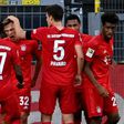Bayern Munich midfielder Joshua Kimmich (C) celebrates scoring the winning goal at Borussia Dortmund.