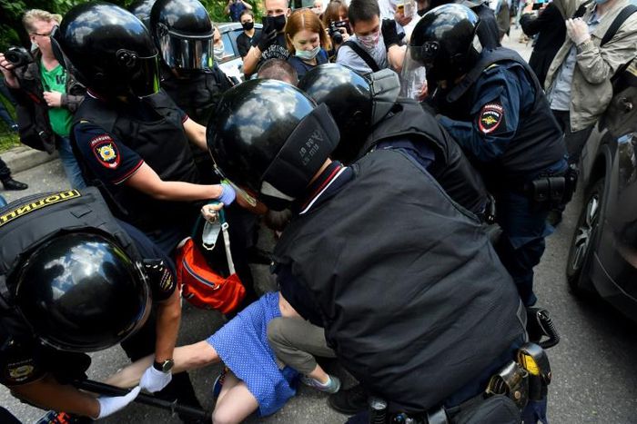 Dozens protested outside the court, setting off a smoke bomb and scattering leaflets that read 'Russia will be free!'