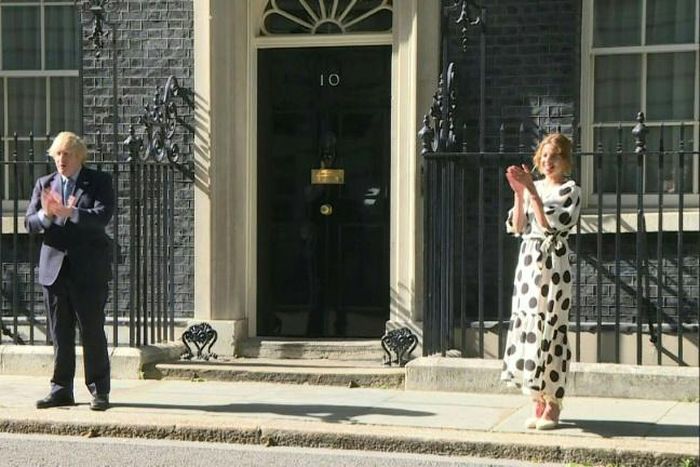 British Prime minister Boris Johnson and 'Clap for Carers' founder Annemarie Plas clap for the NHS outside 10 Downing street