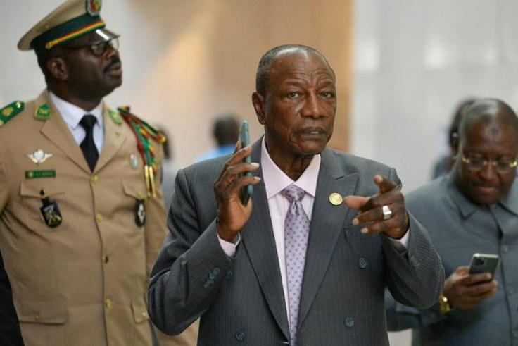 Critics say Alpha Conde, centre, has pushed through constitutional changes designed to let him stay in office