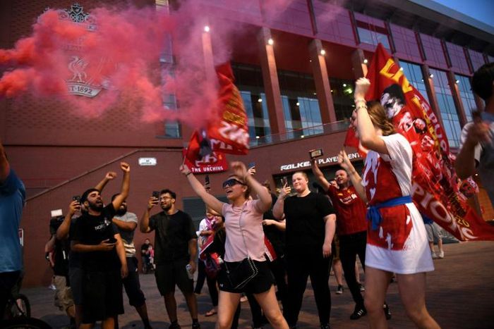 Liverpool fans celebrate winning the Premier League outside Anfield