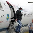 Passengers wearing masks get off a plane at Zagreb International Airport Croatia, on May 11, 2020