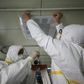 Medical staff seal a vent in what used to be an isolation ward for patients infected by the COVID-19 coronavirus at a hospital in Wuhan, China