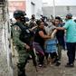 A woman collapses near the drug rehabilitation center where 24 people were killed in Irapuato, Guanajuato state, Mexico, on July 1, 2020