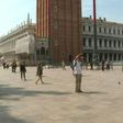 People walk around St Mark's Square in Venice, Italy, with some taking pictures of the famous sites as the country reopens to tourists from Europe after a months-long coronavirus lockdown