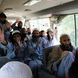 Taliban fighters wave on a bus after being released from prison in Bagram in a handout photograph released Afghanistan's National Security Council
