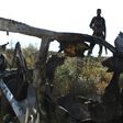 An Iraqi fighter with the Hashed al-Shaabi paramilitary force inspects the site of an attack by Islamic State group in early May 2020 in Mukaishefah, about 180 kilometers (110 miles) north of Baghdad