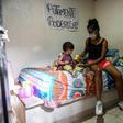 A Medellin sex worker and her young daughter sort through a food package donation