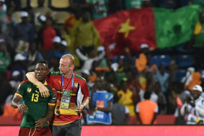 Midfielder Christian Bassogog (L) and assistant coach Sven Vandenbroeck celebrate after Cameroon won the 2017 Africa Cup of Nations final against Egypt in Libreville