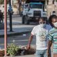 Two men wear masks as they walk in the streets of downtown Port-au-Prince on March 26, 2020. When the novel coronavirus first appeared  in Haiti authorities and humanitarian experts panicked, worried about the country's decrepit health system -- but he...