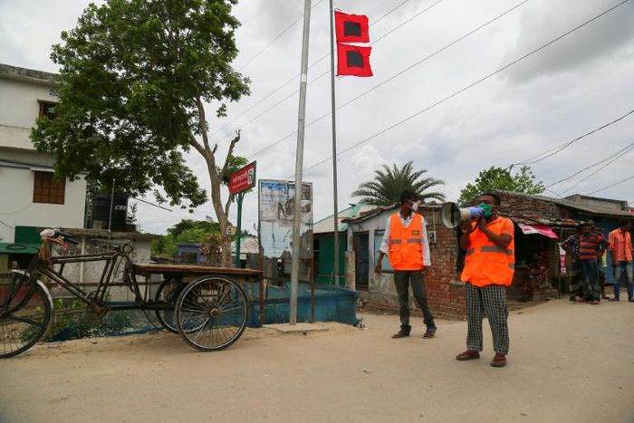 Volunteers urge people to evacuate to shelters ahead of the expected landfall of Cyclone Amphan in Khulna, Bangladesh