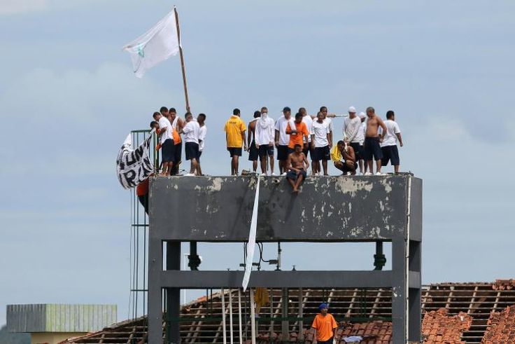 Inmates are seen on the top of a tower of the Puraquequara prison during a rebellion to demand better conditions as the coronavirus rages inside, in Manaus, Amazona State, Brazil, on May 2, 2020