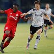 Toronto FC's Ayo Akinola battles with Jukka Raitala of the Montreal in Toronto's 4-3 victory over the Impact in the MLS is Back Tournament in Orlando, Florida