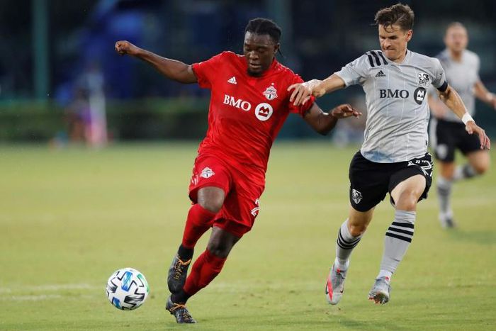 Toronto FC's Ayo Akinola battles with Jukka Raitala of the Montreal in Toronto's 4-3 victory over the Impact in the MLS is Back Tournament in Orlando, Florida