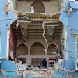 A Lebanese couple inspect the damage to their home in the capital's Gemmayzeh neighbourhood which overlooks the destroyed port of Beirut