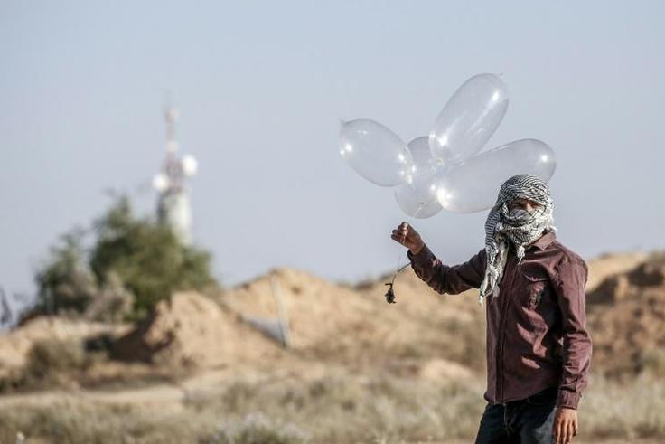 Palestinian militants have been using improvised balloons to carry incendiary materials across the Gaza border into Israel, which imposes a tight blockade on the enclave