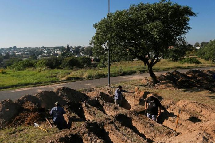 Grave diggers prepare plots at the San Vicente cemetery in Cordoba following a spike in coronavirus cases