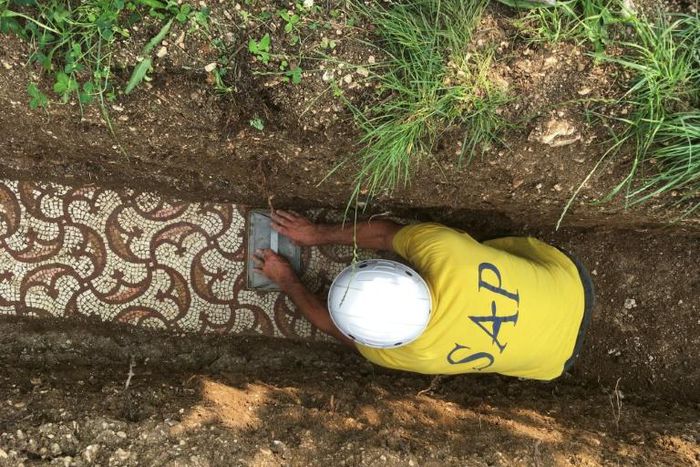 The brightly coloured geometric design is thought to have been part of a villa archaeologists first started looking for in 1922