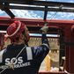 A crew member of French NGO SOS Mediterranee rescue boat Ocean Viking paints parts of the boat moored in the port of Marseille, on the eve of a scheduled departure for a migrants search and rescue mission off the coast of Libya