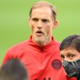 Paris Saint-Germain coach Thomas Tuchel stands behind the club's Brazilian sporting director Leonardo before their team's training session at the Stade de France on Thursday