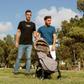 Harel Barak (L) and his husband Yakir Kanneli (R) pose for a picture with an empty stroller at a park in the Israeli coastal city of Tel Aviv