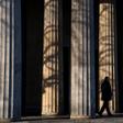 A guard walks past the columns of a memorial in Berlin that will figure in VE day ceremonies