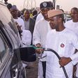 Osinbajo helping out a petrol attendant at an Oando filling station in Lagos