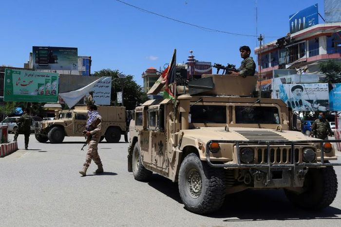 Afghan security forces sit in a Humvee vehicle on May 19 amid fighting between Taliban militants and Afghan security forces in Kunduz