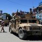 Afghan security forces sit in a Humvee vehicle on May 19 amid fighting between Taliban militants and Afghan security forces in Kunduz
