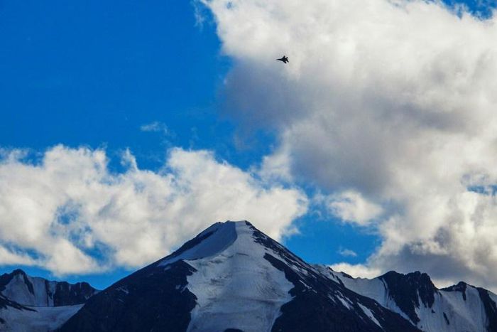 An Indian fighter jet flies over a mountain range in Leh, the joint capital of the union territory of Ladakh