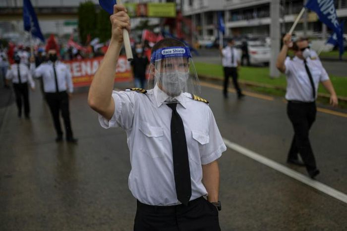 Airline workers join a protest in Panama against government measures to reopen the economy