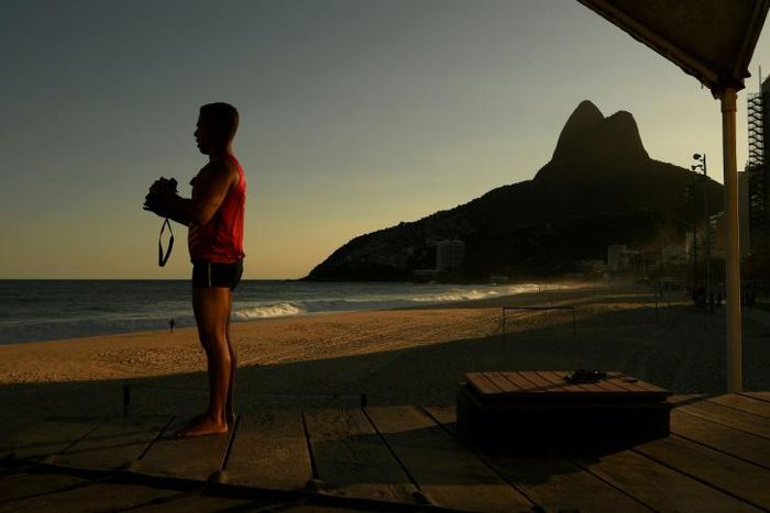 A lifeguard looks out over an empty Ipanema beach as Rio's famous beaches remained closed to all but surfers on April 28, 2020