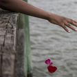 Guests take part in a flower petal throwing ceremony to honor Africans who passed away at sea during the Atlantic slave trade during the 2019 African Landing Commemorative Ceremony on August 24, 2019 in Hampton, Virginia