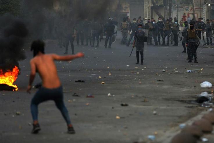 Iraqi demonstrators clash with security forces in al-Tayaran square in central Baghdad on Monday during ongoing anti-government protest over poor public services