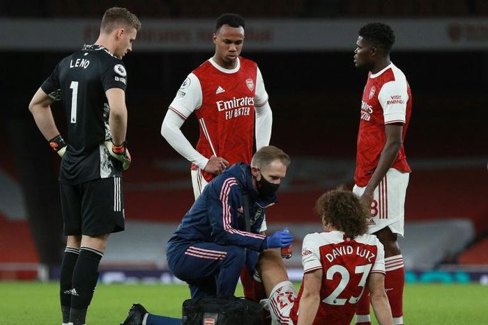 Arsenal defender David Luiz receives medical treatment at the Emirates Stadium