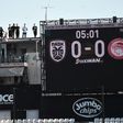 Roof dwellers: PAOK fans watch the Greek Super League game against Olympiakos above the Toumba stadium in Thessaloniki