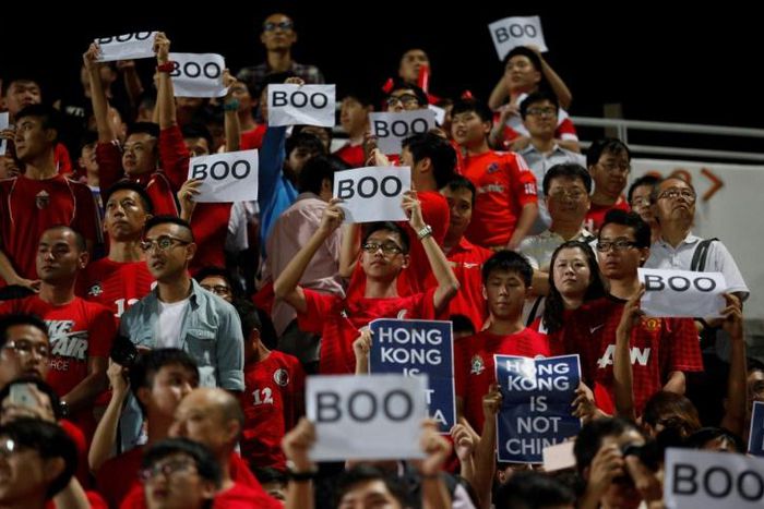 Hong Kong fans hold up signs that read "Boo" in 2015 during China's national anthem before a qualifying match for the 2018 World Cup at Mong Kok stadium in Hong Kong