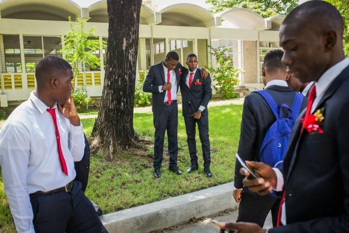 Seniors at Saint-Louis de Gonzague school in Port-au-Prince, Haiti, gather after their graduation photo on August 4, 2020; with Haitian schools set to reopen nationwide, a huge opportunity gap separates them