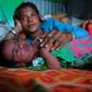 Manju Bauri rests with her newborn baby boy 'Lockdown' in their temporary home in northeast India