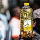 Inflation anger: A protester holds a bottle of cooking oil during a demonstration in Harare last August over the cost of food