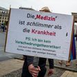 Protesters claiming that 'the cure is worse than the disease'