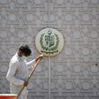 A man sweeps in front of the main gate of the Pakistan High Commission in New Delhi